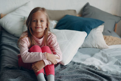 Portrait of girl on bed at home