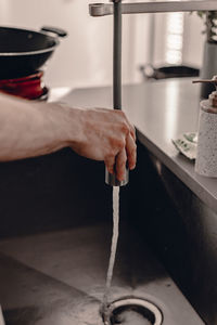 Midsection of person working in kitchen