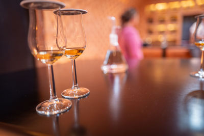 Close-up of wine glasses on table