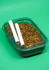 High angle view of cigarette in container on table