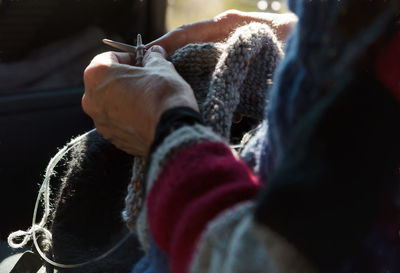 Close-up of person knitting