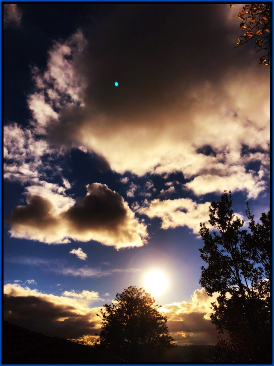 sky, cloud - sky, silhouette, beauty in nature, tree, sunlight, sun, nature, sunset, plant, tranquility, low angle view, no people, tranquil scene, transfer print, scenics - nature, lens flare, outdoors, sunbeam, auto post production filter, bright, solar flare, brightly lit, moonlight