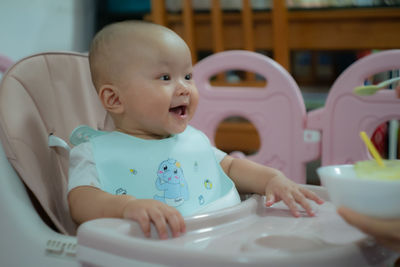 Portrait of cute baby boy in bathtub at home