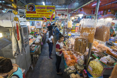 People at market stall in city