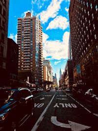 City street and buildings against sky