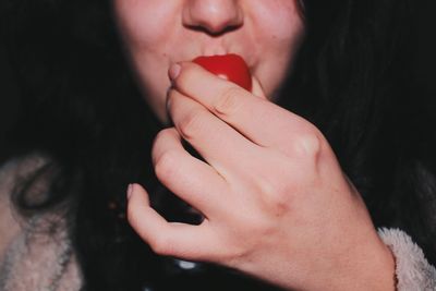 Close-up of woman eating tomato