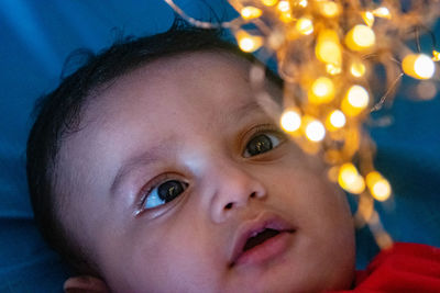 Close-up portrait of cute baby looking strangely at l8ght