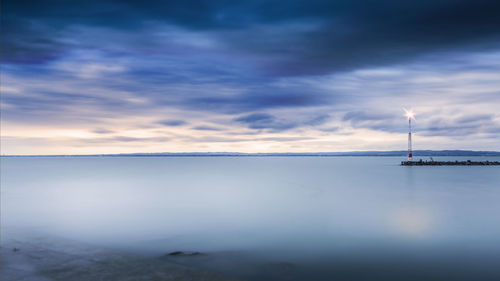 Scenic view of calm sea against blue sky