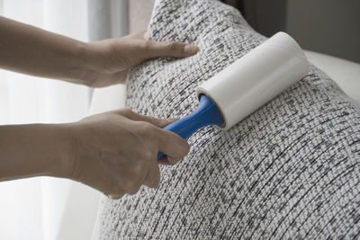 Close-up of woman holding hands at home