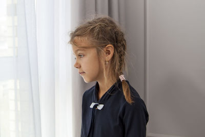 Portrait of girl looking away at home