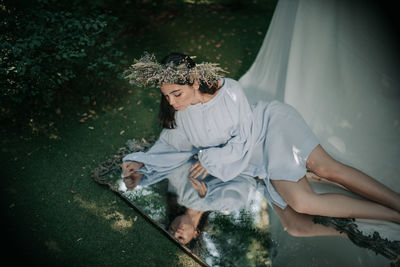 High angle view of woman sitting outdoors