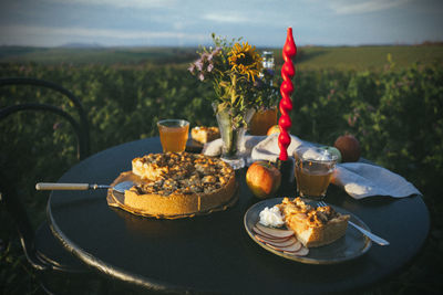Close-up of apple pie served on table in a field