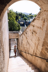 Rear view of man walking on steps