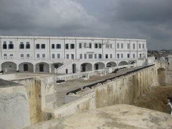 View of old building against cloudy sky