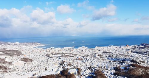 Panoramic view of sea and buildings against sky