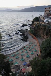 High angle view of buildings by sea against sky