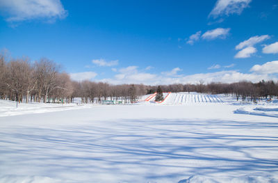 Snow covered field against sky