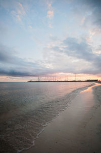 Scenic view of beach against sky during sunset