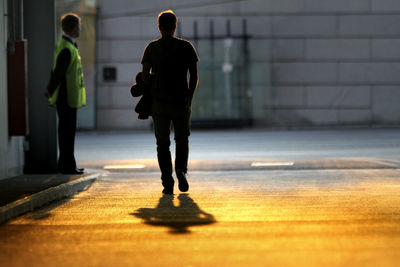 Full length of man walking on road