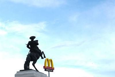 Low angle view of statue against sky