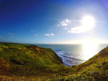 Scenic view of sea seen from mountain against sky