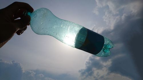 Low angle view of hand against sky