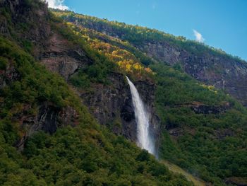 Scenic view of waterfall against sky