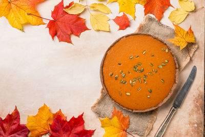 High angle view of autumn leaves on table