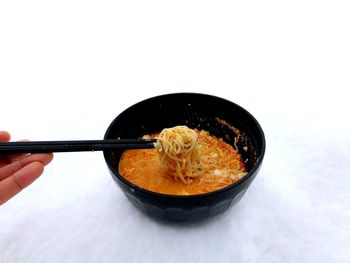 Close-up of person holding ice cream in bowl
