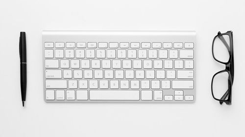 Directly above shot of computer keyboard against white background