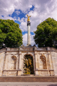 Low angle view of statue against cloudy sky