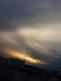 Low angle view of silhouette building against sky