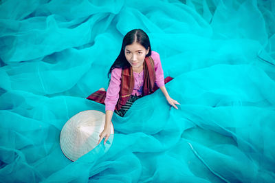 Portrait of smiling young woman in swimming pool