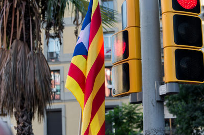 Multi colored flags hanging on pole in building