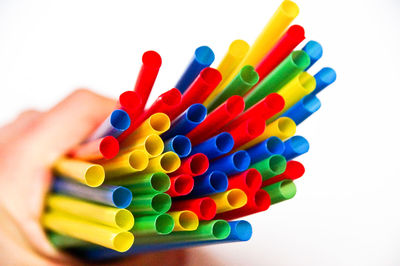 Close-up of colorful hand over white background