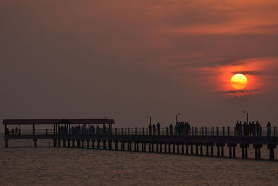 Silhouette pier on sea against sky during sunset