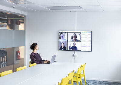 Woman in boardroom having video conference