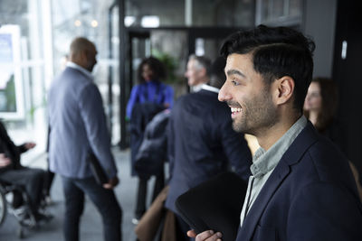 Surprised businessman standing in lobby during seminar at conference center