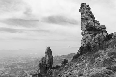 One person poses balancing in the middle of a highline in los frailes