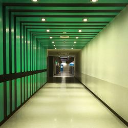 Empty corridor in illuminated building