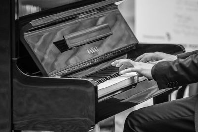 Close-up of hands playing piano