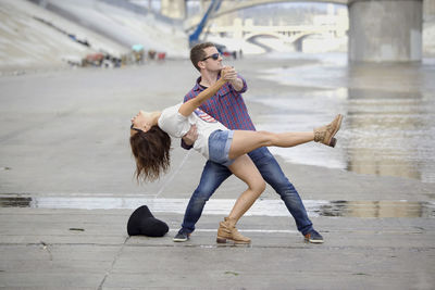 Full length of young woman jumping