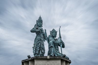 Low angle view of statue against cloudy sky