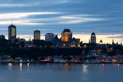 Quebec city old town skyline seen at night with the st. lawrence river in the foreground