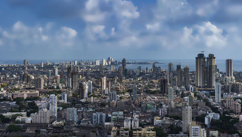 Aerial view of modern buildings in city against sky