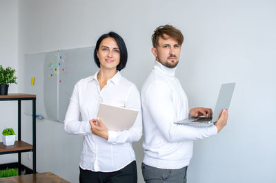 Work colleagues, a man and a woman in the office