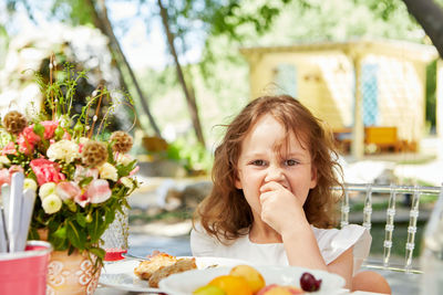 Portrait of girl eating food at cafe