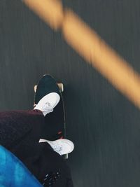 Low section of man skating on road