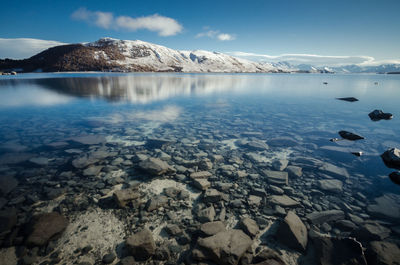 Scenic view of lake against sky during winter