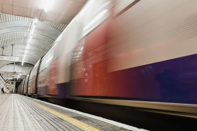 Blurred motion of train at railroad station